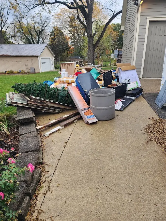 Dumpster being loaded with debris for 12 Yard Dumpster Rental in Bensville